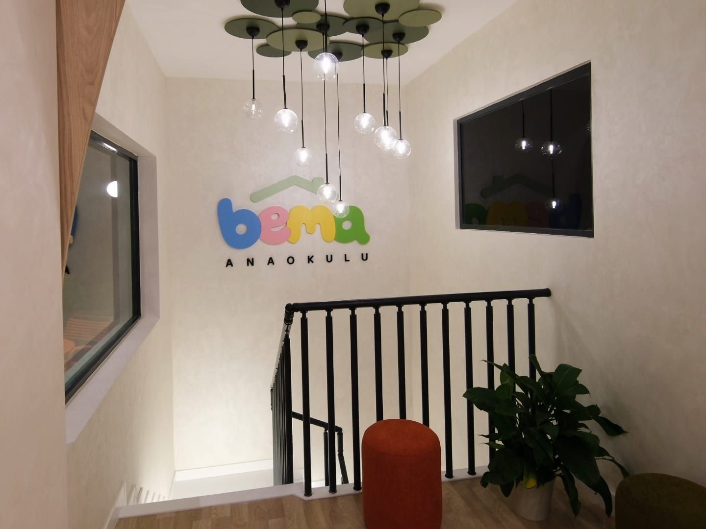 BEMA logosu, merdiven korkuluğu, puf ve bitkiyle giriş holü